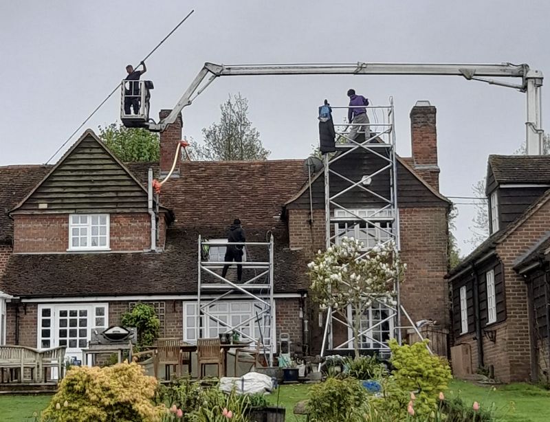 The Roof Moss Cleaners using cherry picker and scaffolding to clean roof safely and professionally in Welwyn Garden City, Hertfordshire